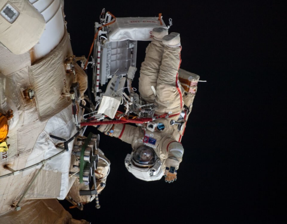 (April 18, 2022) --- Cosmonaut Oleg Artemyev waves to the camera while working outside the Nauka multipurpose laboratory module during a spacewalk that lasted for six hours and 37 minutes to outfit Nauka and configure the European robotic arm on the International Space Station's Russian segment.