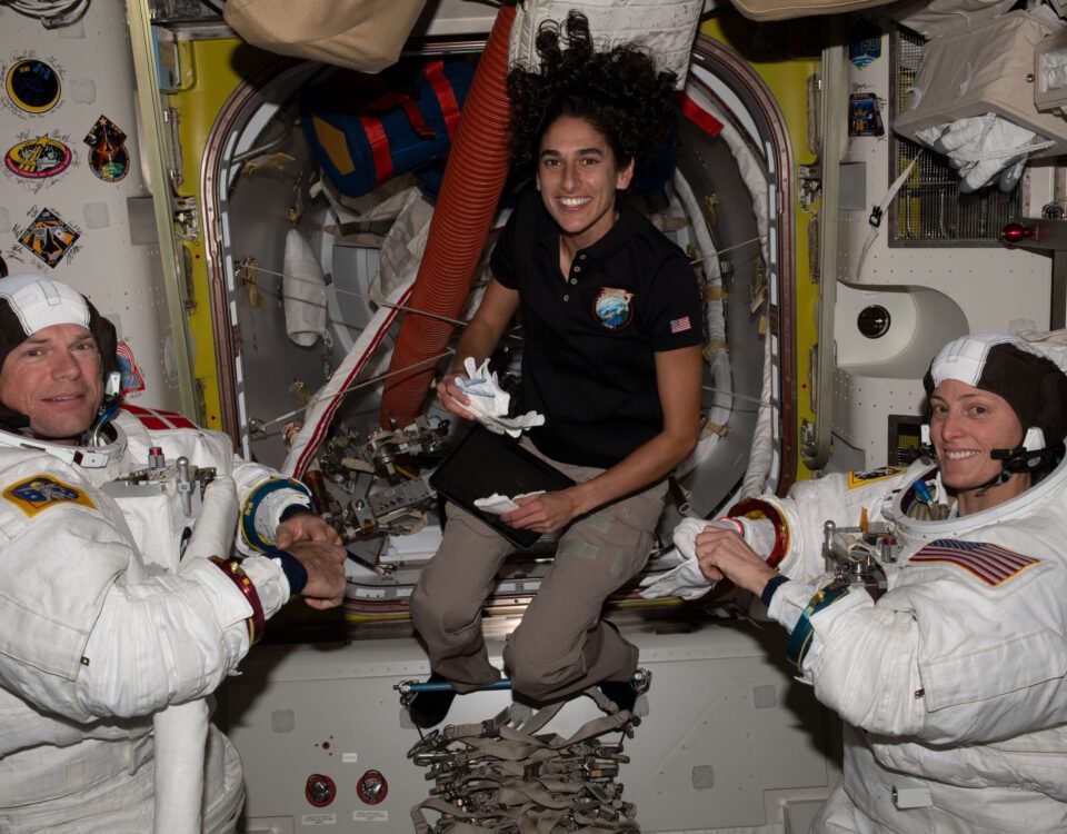 NASA astronaut Jasmin Moghbeli (center) assists astronauts Andreas Mogensen (left) from ESA (European Space Agency) and Loral O'Hara (right) from NASA as they try on their spacesuits and test the suits' components aboard the International Space Station's Quest airlock in preparation for an upcoming spacewalk.