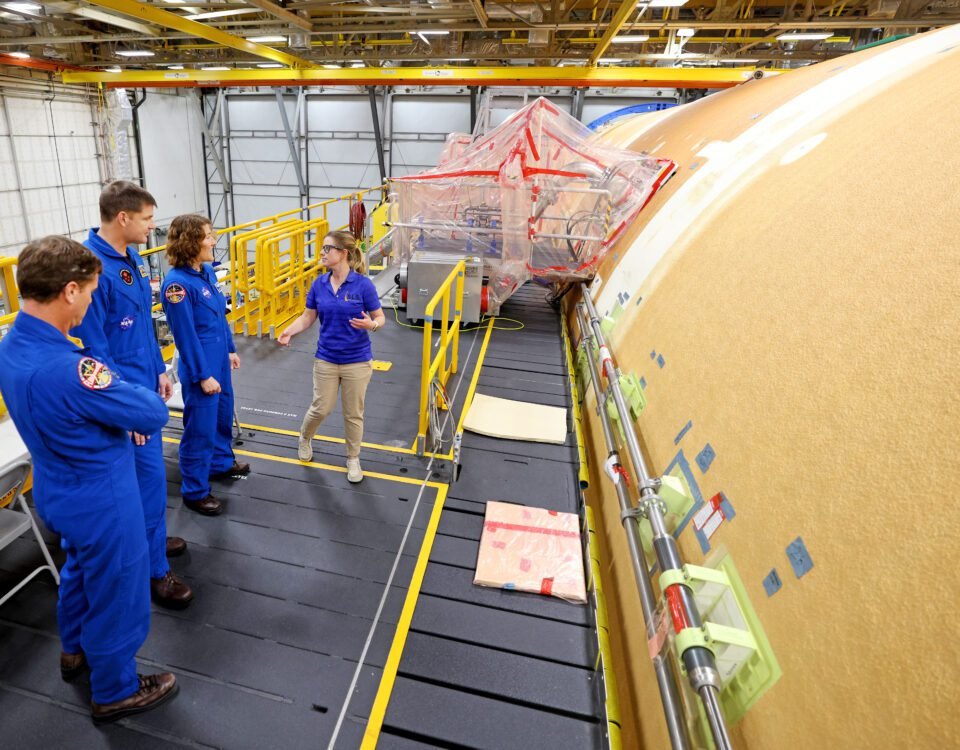 Artemis II NASA astronauts Reid Wiseman and Christina Koch of NASA, and CSA (Canadian Space Agency) astronaut Jeremy Hansen view the core stage for the SLS (Space Launch System) rocket at the agency’s Michoud Assembly Facility in New Orleans on Nov. 16.